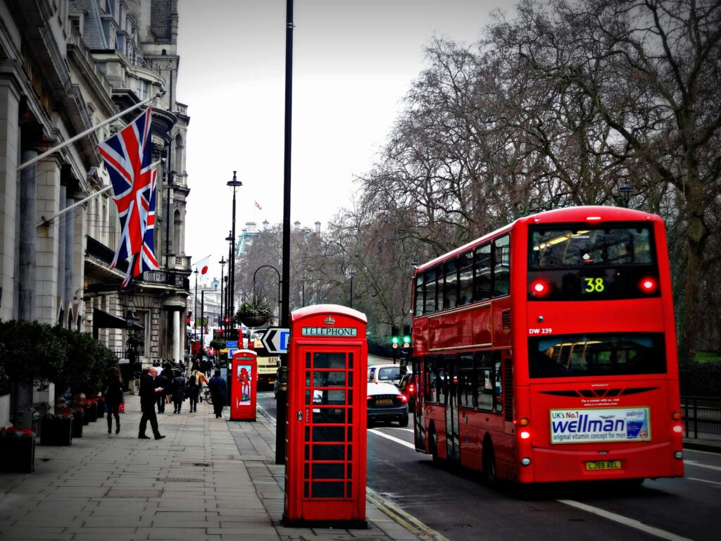 UK Visa Refused? Here’s Exactly What to Do Next (Step-by-Step Guide) Classic London scene featuring a red double-decker bus and iconic phone booth on a busy city street.